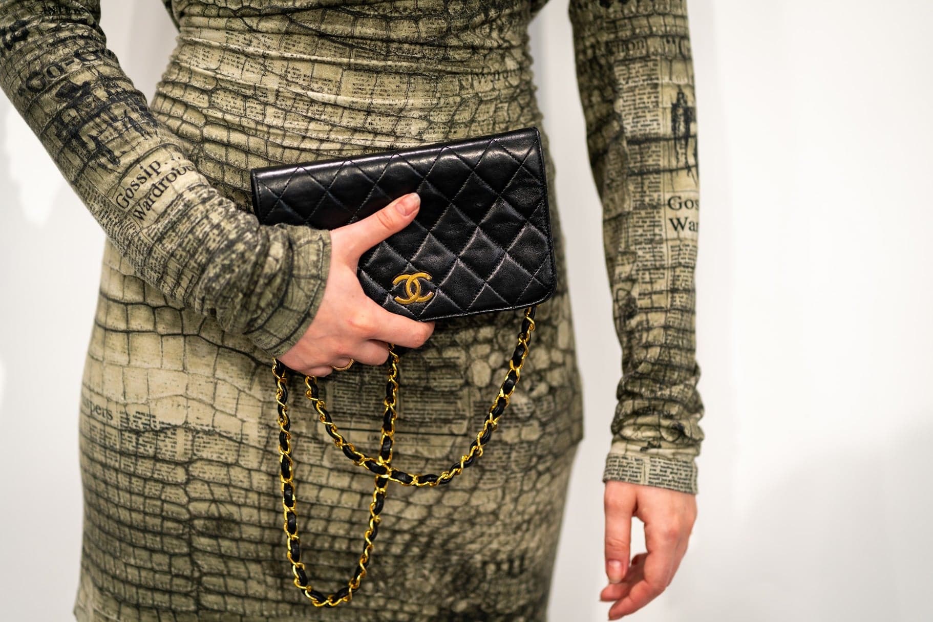 Quilted flap bag against a printed dress